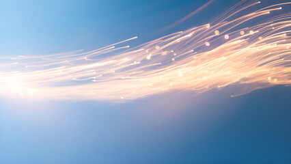 An abstract image showcasing soft light trails against a blue background, creating a sense of movement and fluidity.