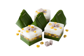 Homemade Thai pudding topped with coconut, wrapped in banana leaves (Tako), set against a white background. It's a jelly-like coconut cream with corn and taro on top. A well-known Thai dessert.