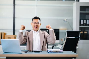 Cheerful businessman checking time feeling motivated waiting for leaving office do on their tablet, laptop and taking notes at office