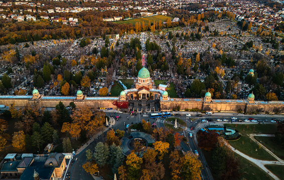 Aerial view of Mirogoj Cemetery's grand architecture, a serene dome amidst a landscape of autumnal hues and orderly rows of graves, Zagreb, Zagreb, Croatia.