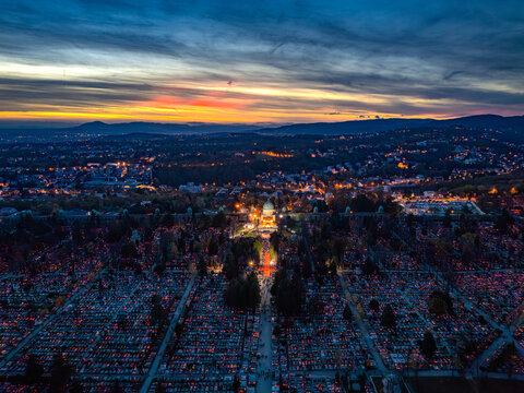 Aerial view of the illuminated Mirogoj Cemetery, with its arcades and dome glowing softly against the twilight sky, Zagreb, Zagreb, Croatia.