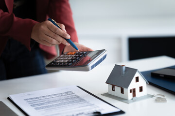 financial expert reviews house contract and loan calculation in office