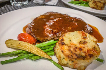 Beef steak, vegetable, tomato, mashed potatos on white dish