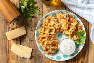 Crispy cheese waffles on a rustic background. Top view flat lay.