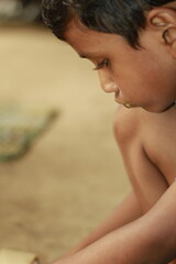 Close-up view of a young child eating homemade food, with small bits of food around the mouth,  innocence of childhood mealtime and the emotional bond of being lovingly fed by a caring hand.