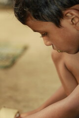 Close-up view of a young child eating homemade food, with small bits of food around the mouth,  innocence of childhood mealtime and the emotional bond of being lovingly fed by a caring hand.