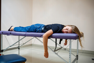 Relaxation session at a wellness center as a woman enjoys a peaceful moment on a massage table in the sunlight