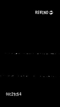 VHS video tape rewind overlay with distorted and scratches effect and timecode on black background. 4K Video.