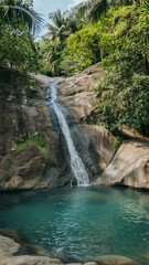 Fototapeta premium Tropical waterfall cascading into a clear blue pool