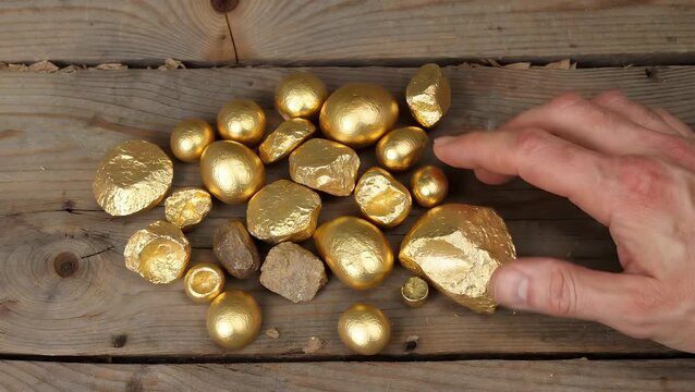 Sample of Unrefined Gold Ore Freshly Extracted from a Mining Operation and Positioned on an Aged Wooden Plank