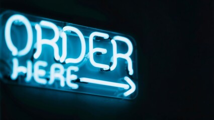 Retro 'Order Here” bent neon sign with arrow glowing on black background