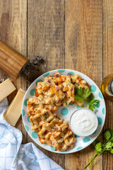 Crispy cheese waffles on a rustic background. Top view flat lay.