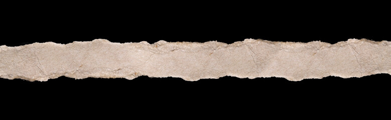 Isolated horizontal strip of torn light brown cardboard paper runs across the center of the image on a black background and clipping path.