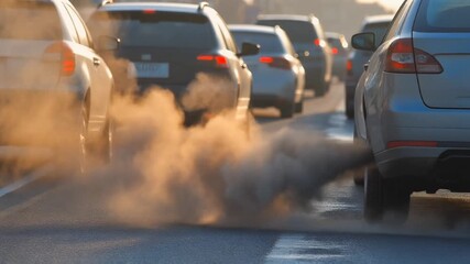 Thick plume of automotive exhaust smoke polluting the air in heavy traffic congestion. - Powered by Adobe