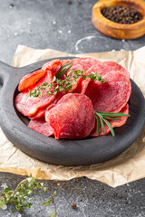 Cold smoked meat, pork chops on gray background vertical photo