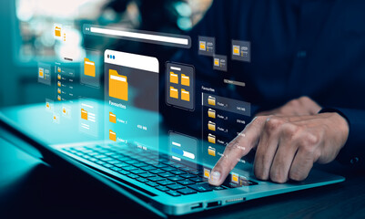 Person using laptop with virtual file folders and digital interface. Concept of cloud storage, data management system, information organization, and modern business technology.