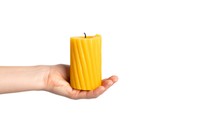 A hand gently cradling a brightly colored candle, casting a warm and inviting glow