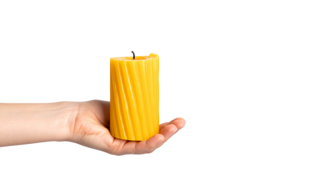 A hand gently cradling a brightly colored candle, casting a warm and inviting glow