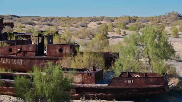 Several rusted out fishing boats in the Moynaq ship graveyard in Uzbekistan