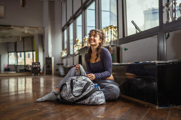 Happy young woman resting after dance training