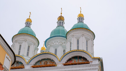 Close-up of elements of the domes of the Astrakhan Kremlin with a bell tower on a cloudy day. Astrakhan, Russia