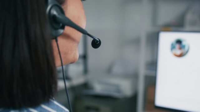 Close up of Asian Call Center Agent, Businesswoman working, talking to client online Customer Support using computer Operator, Telemarketing and Consulting to Client sit at help desk in office.