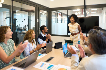 Diverse business team applauding successful presentation