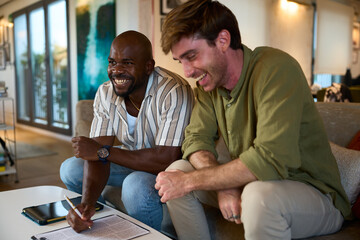 Diverse men laughing celebrating signing contract - Financial, insurance and legal advisory
