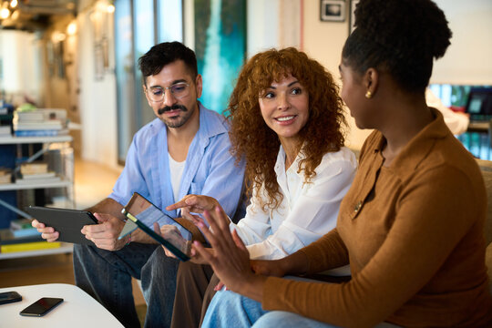 Diverse colleagues collaborating on digital tablets in office - Financial, insurance and legal advisory