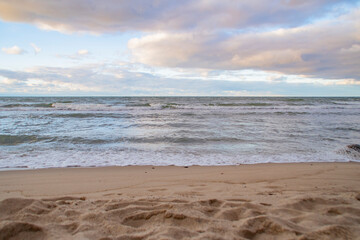 An ordinary evening coastline with an empty sandy beach.