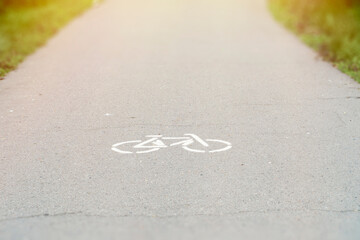 A close-up of a bicycle sign on the road. A dedicated lane for cyclists. A blank background with a road.