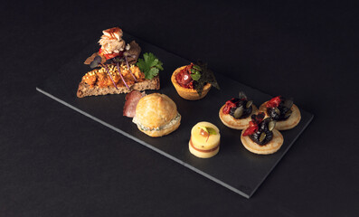 Close-up gourmet canape with fish and roasted vegetables
