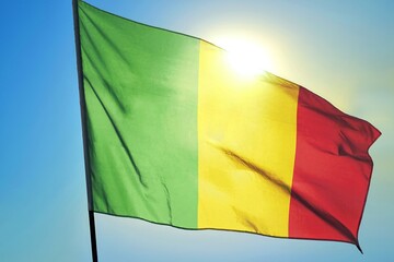 Mali national flag waving in sunlight close-up &ndash; Malian vertical tricolor green yellow red banner patriotic West African country symbol background blue sky bright sunny day