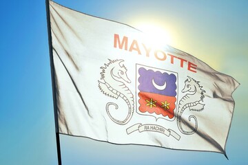Mayotte territorial flag waving in sunlight close-up &ndash; French overseas region banner with coat of arms seahorses crescent moon flowers emblem white fabric patriotic background blue sky bright sunny da