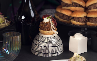 Gourmet mini tart with meat topping and sun dried tomato