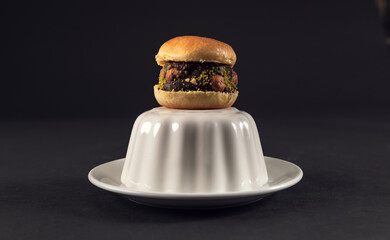 Chocolate mini cake with walnut topping on black plate