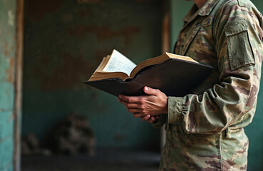 Soldier in camouflage uniform reads holy bible indoors. Male military person holds open book praying to god for support. Faithful serviceman studies scripture seeking hope finding spiritual strength