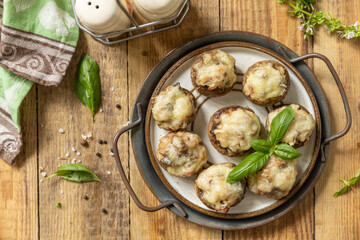 Stuffed mushrooms baked with cheese on rustic background. Top view flat lay background.  