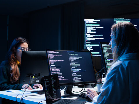 Group of A multicultural Software Developer working on laptop computer Writing Code on Desktop Computer in Co working Office Space. Professional Programmer Working on Coding Development Startup.