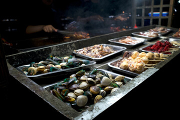 A variety of delicious clams, crab, shrimp, squid at street food carts in Indonesia