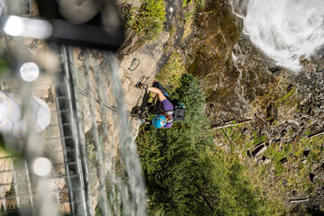 Obraz premium Dramatic Stuibenfall waterfall in the Ötztal Alps with via ferrata, viewpoints and footbridges, powerful alpine nature spectacle in Tyrol, Austria.