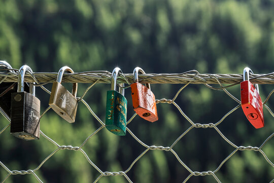 Love locks attached to a fence at the Stuibenfall waterfall in the Ötztal Alps, scenic alpine nature spectacle with via ferrata, viewpoints and footbridges in Tyrol, Austria.
