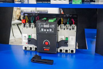 Modern Automatic Transfer Switch (ATS) system with intelligent controller and circuit breakers on a blue surface. Essential electrical equipment for reliable power management, ensuring seamless transi
