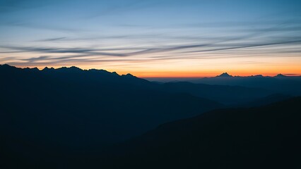 Mountain landscape bathed in twilight hues of deep blue and fading sunset colors.