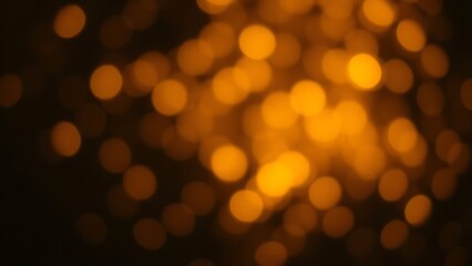 Dreamy golden bokeh sparkles on a dark background creating an atmospheric glowing effect.