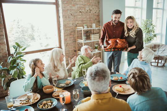 Thanksgiving family feast brings generations together around a big table with turkey smiles and warm memories - Powered by Adobe