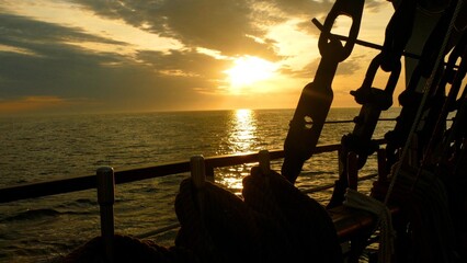 sunset through the rigging of an old sailing ship