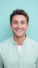 Smiling Young Man in Pastel Green Shirt on Mint Background