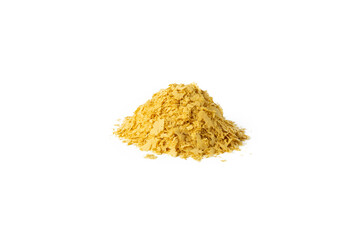 Savoury vegan yeast flakes heap isolated on white background.