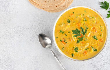 Mulligatawny soup with lentils vegetables with chapati flatbreads on white background. Top view. Copy space. Indian food